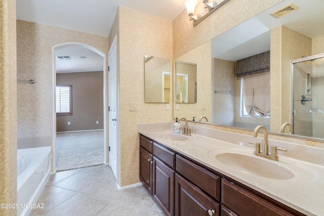 full bath featuring visible vents, wallpapered walls, and a sink