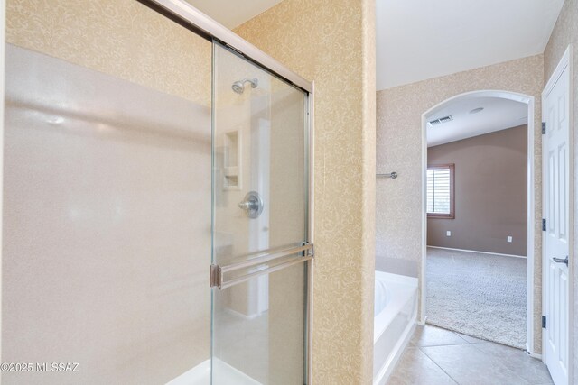 full bathroom featuring tile patterned floors, wallpapered walls, a stall shower, a garden tub, and visible vents