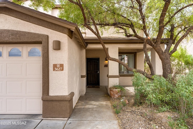 property entrance with stucco siding