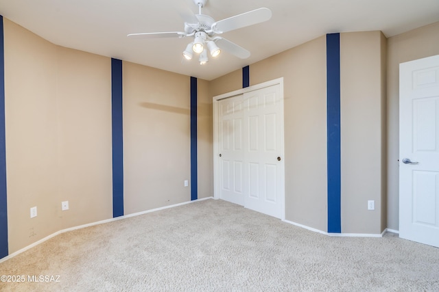 unfurnished bedroom featuring carpet flooring, baseboards, and ceiling fan