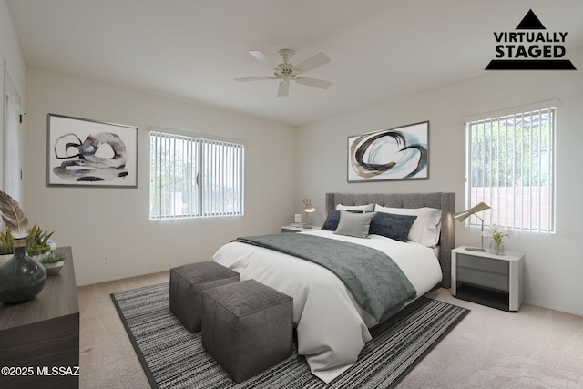 bedroom with a ceiling fan, multiple windows, and light carpet