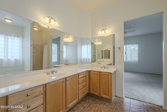 full bathroom with double vanity, tile patterned floors, a ceiling fan, and a sink
