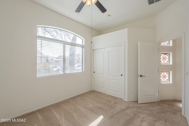 unfurnished bedroom featuring baseboards, a closet, and light colored carpet