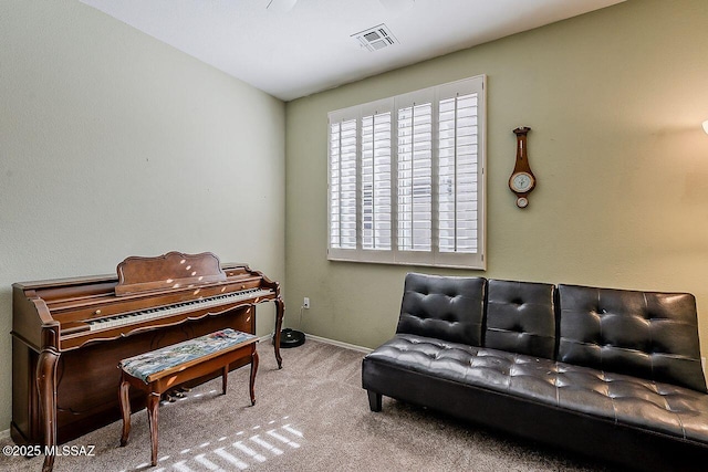 sitting room with carpet, baseboards, and visible vents