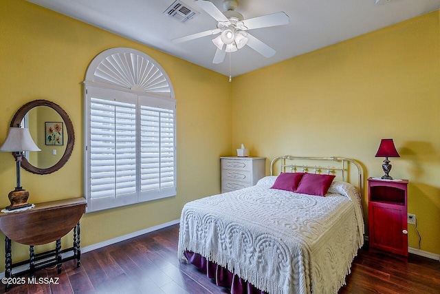 bedroom featuring baseboards, ceiling fan, visible vents, and wood finished floors