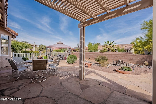 view of patio / terrace with a fenced backyard, a pergola, a gazebo, and outdoor dining space