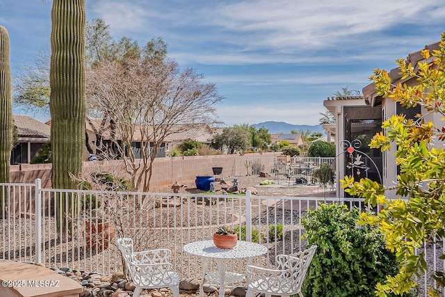 view of yard with a fenced backyard, a patio area, and a mountain view