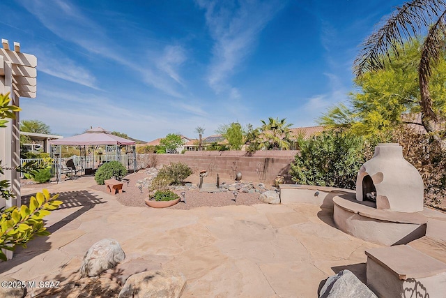 view of patio featuring a fenced backyard and a gazebo