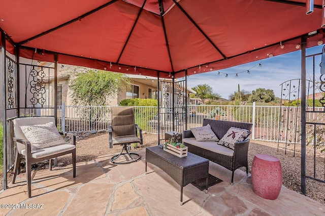 view of patio featuring outdoor lounge area, a gazebo, and fence