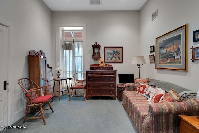 living area featuring visible vents and carpet floors
