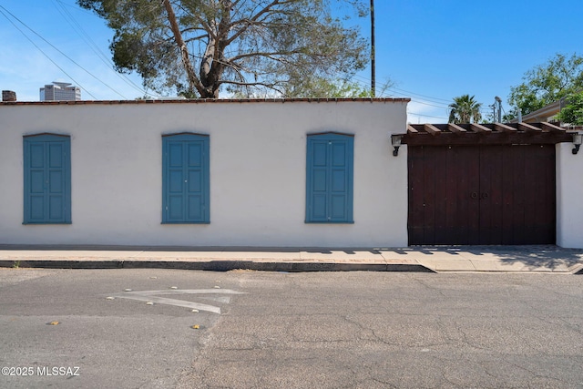 view of side of home with stucco siding