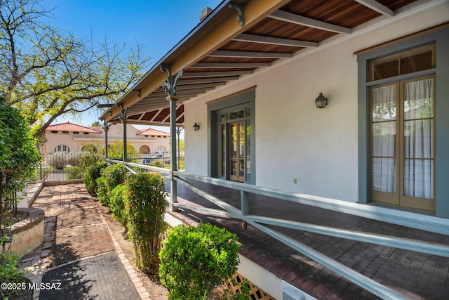 view of patio with french doors and fence