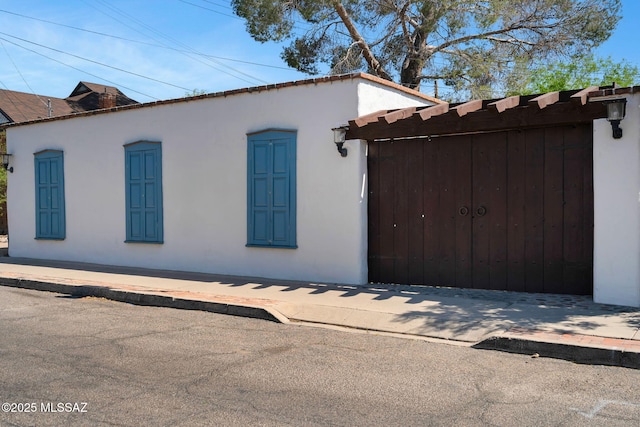 view of home's exterior featuring fence and stucco siding