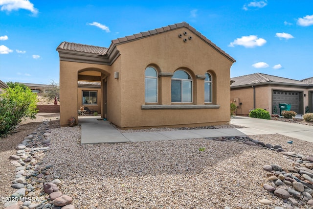 exterior space featuring stucco siding and a tiled roof