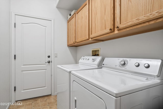 laundry room featuring independent washer and dryer and cabinet space
