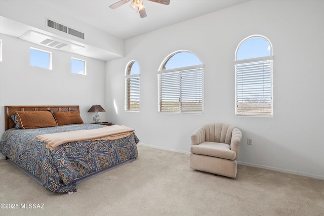 carpeted bedroom featuring baseboards, ceiling fan, and visible vents