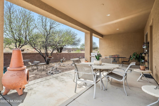 view of patio / terrace with outdoor dining area and fence