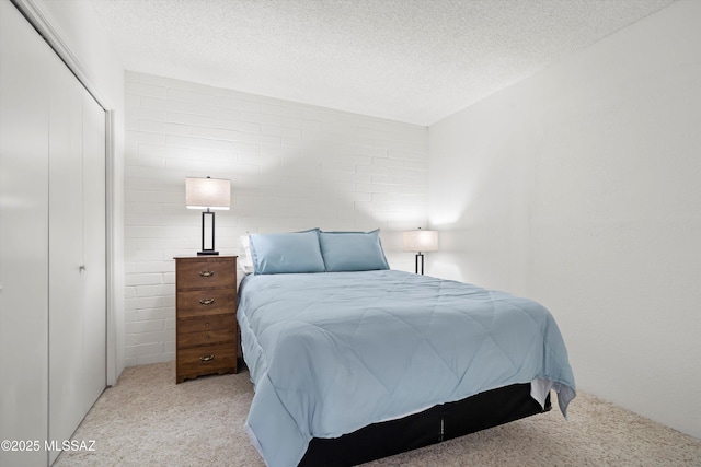 bedroom featuring a closet, carpet flooring, and a textured ceiling