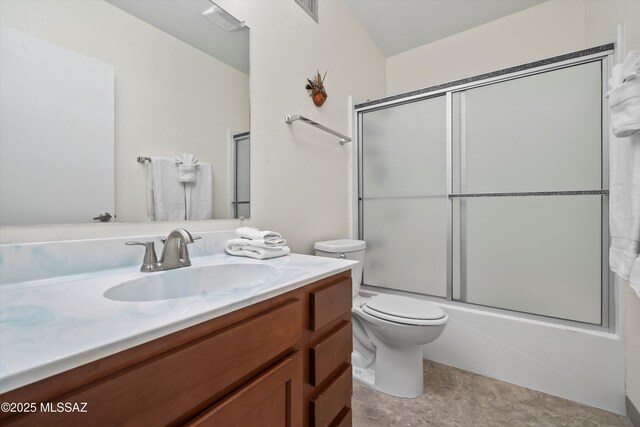 bathroom with toilet, vanity, and shower / bath combination with glass door