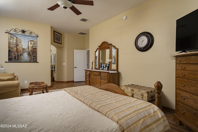 bedroom featuring baseboards, visible vents, arched walkways, and dark wood-style flooring