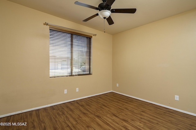 empty room featuring baseboards, ceiling fan, and wood finished floors