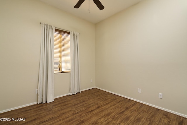 unfurnished room with baseboards, dark wood-type flooring, and a ceiling fan