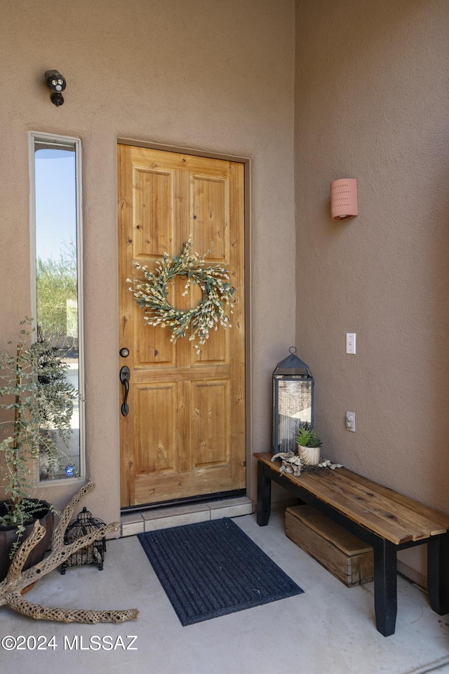 entrance to property featuring stucco siding