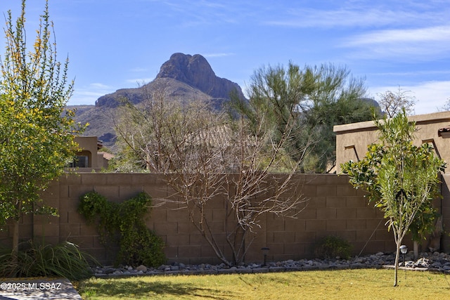 view of yard featuring a mountain view and fence