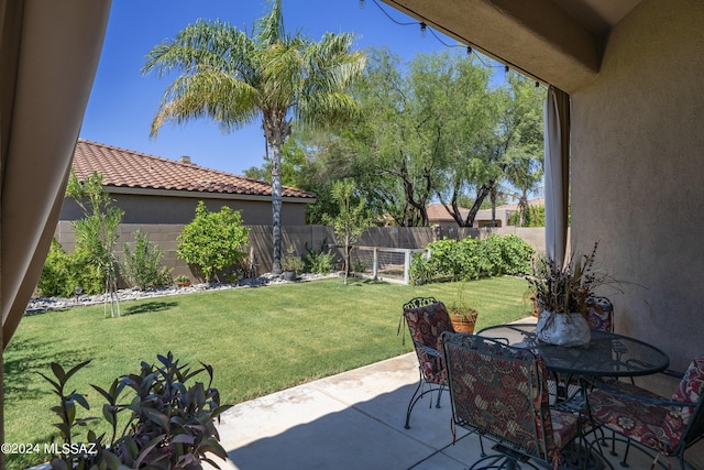 view of patio with a fenced backyard and outdoor dining space