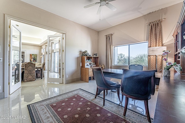 dining area featuring baseboards and a ceiling fan