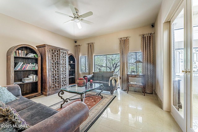 living room featuring french doors, marble finish floor, and a ceiling fan