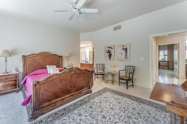 carpeted bedroom featuring a ceiling fan, visible vents, and connected bathroom