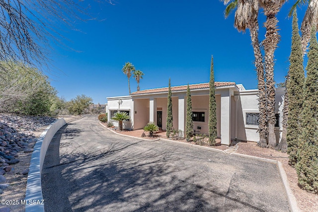 view of front of property featuring a tile roof and stucco siding