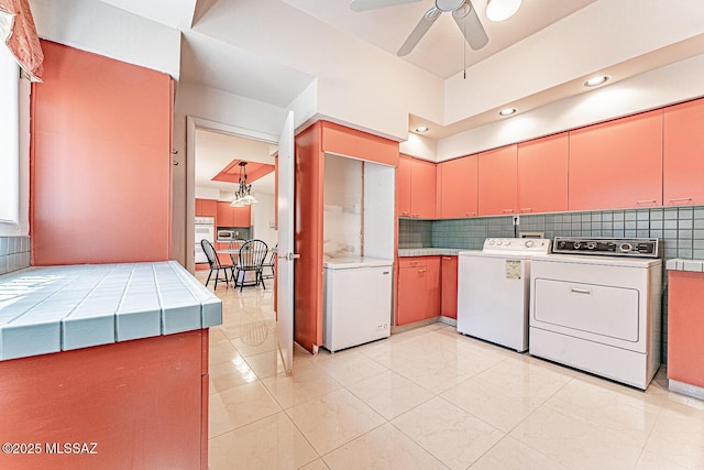 kitchen featuring washer and clothes dryer, refrigerator, backsplash, and ceiling fan