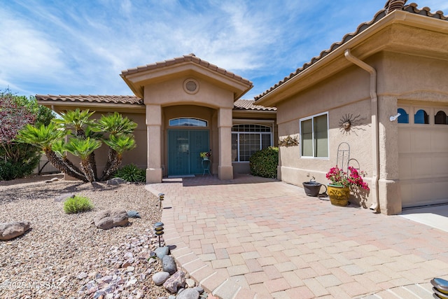 mediterranean / spanish home with stucco siding and a tile roof