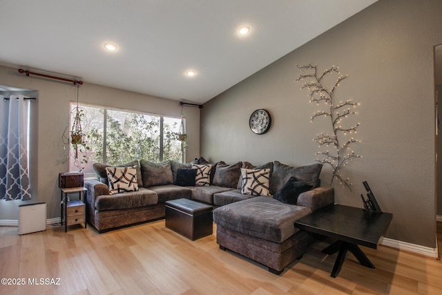 living area with baseboards, vaulted ceiling, light wood-style floors, and recessed lighting