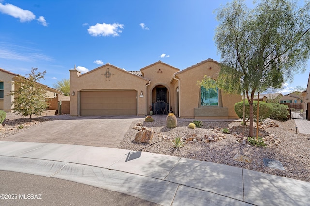 14082 N Tiyo Point Trl, Marana, AZ 85658 - mediterranean / spanish-style house with stucco siding, decorative driveway, fence, a tile roof, and an attached garage