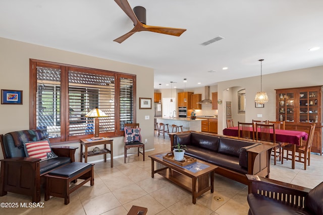 14082 N Tiyo Point Trl, Marana, AZ 85658 - living area with recessed lighting, light tile patterned floors, visible vents, ceiling fan, and arched walkways
