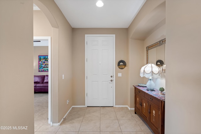 14082 N Tiyo Point Trl, Marana, AZ 85658 - entryway with arched walkways, light tile patterned floors, and baseboards