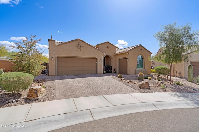 14082 N Tiyo Point Trl, Marana, AZ 85658 - mediterranean / spanish-style home with stucco siding, decorative driveway, a garage, a tiled roof, and fence