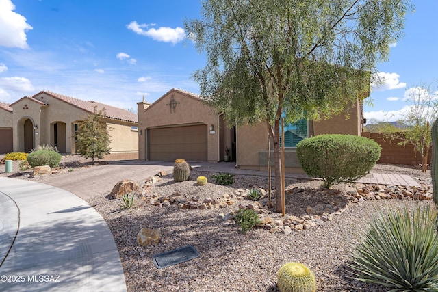 14082 N Tiyo Point Trl, Marana, AZ 85658 - view of front facade with stucco siding, fence, a tile roof, an attached garage, and driveway