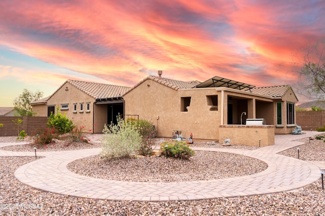 14082 N Tiyo Point Trl, Marana, AZ 85658 - view of front of home with exterior kitchen, stucco siding, fence, and a tile roof