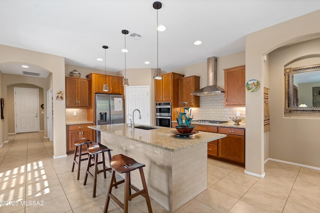 14082 N Tiyo Point Trl, Marana, AZ 85658 - kitchen featuring a sink, brown cabinetry, wall chimney exhaust hood, and stainless steel appliances