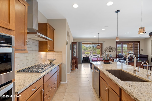 14082 N Tiyo Point Trl, Marana, AZ 85658 - kitchen with backsplash, brown cabinets, wall chimney exhaust hood, appliances with stainless steel finishes, and a sink