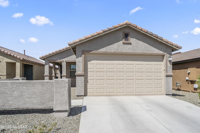 view of front of house featuring a garage, driveway, stucco siding, and a tiled roof