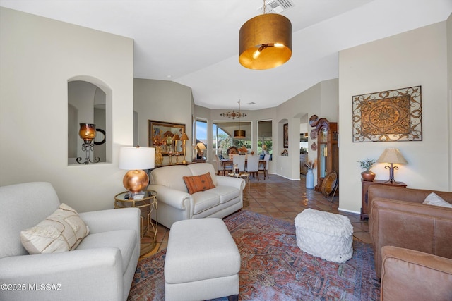 living area featuring visible vents, arched walkways, and tile patterned flooring