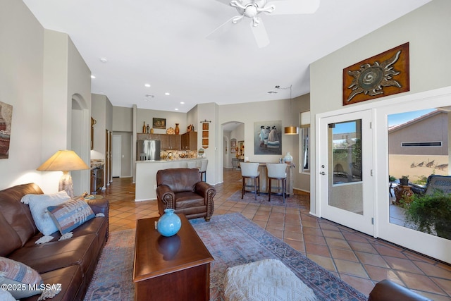 living area featuring ceiling fan, recessed lighting, arched walkways, and light tile patterned flooring