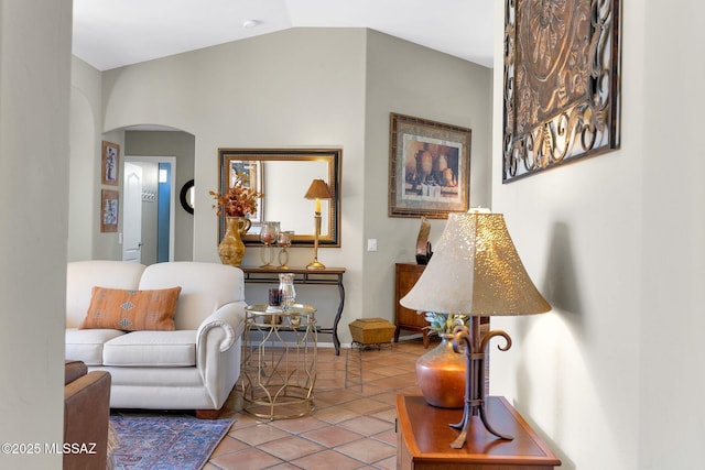 living area with arched walkways, tile patterned flooring, and lofted ceiling