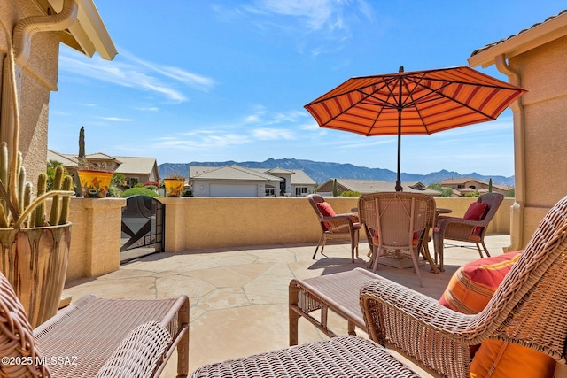 view of patio featuring a mountain view and a balcony