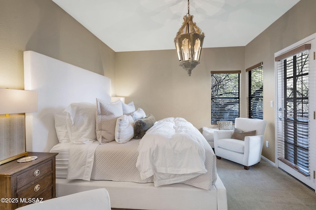 6655 N Canyon Crest Dr Unit 23102, Tucson, AZ 85750 - bedroom with carpet floors, a chandelier, access to exterior, and baseboards